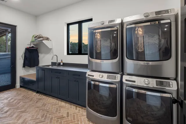 a view of a backyard with potted plants and a large tree
