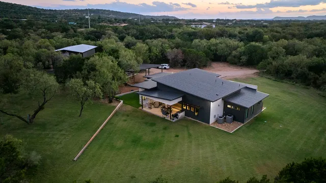 a view of a patio with table and chairs near a yard