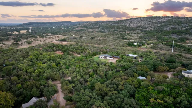 an aerial view of residential houses with outdoor and green space