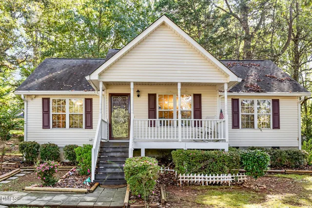 a front view of a house with a garden