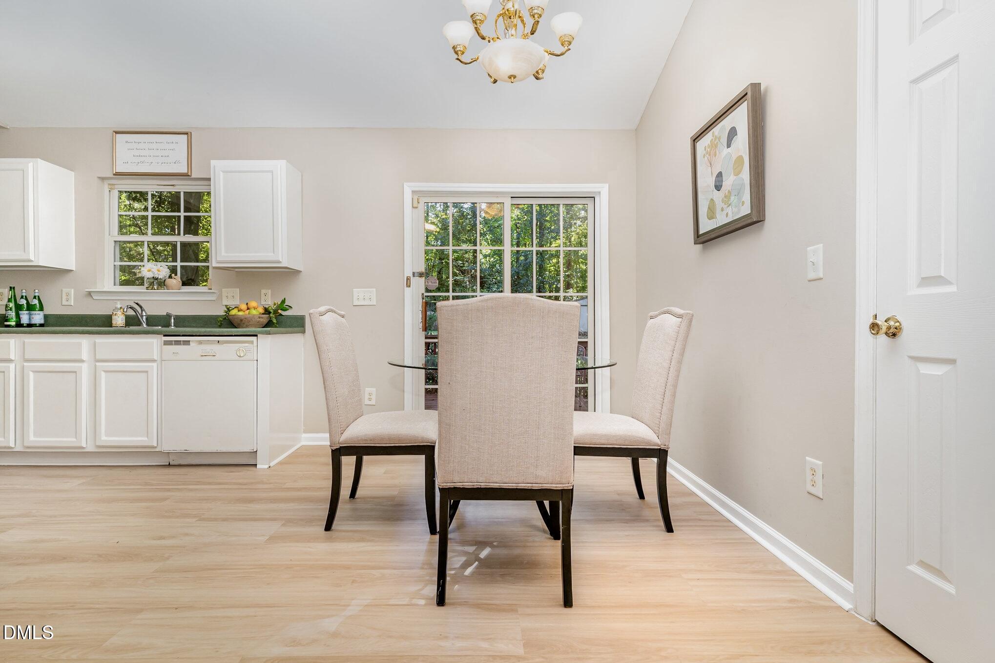 5414 Stanley Road Durham, NC 27704 - Photo 3 of 20 a view of a dining room with furniture window and wooden floor