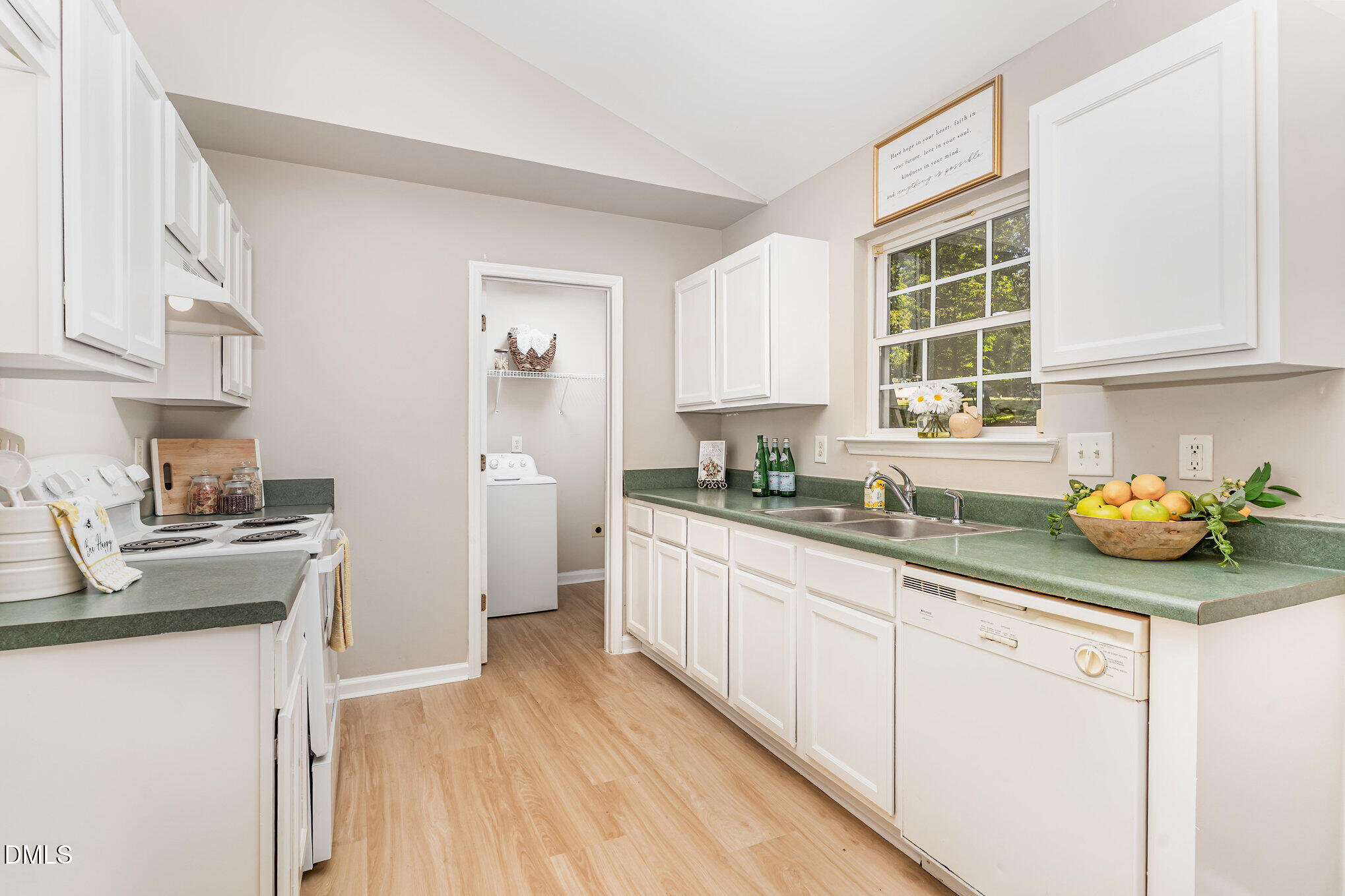 5414 Stanley Road Durham, NC 27704 - Photo 5 of 20 a kitchen with a sink white cabinets and window