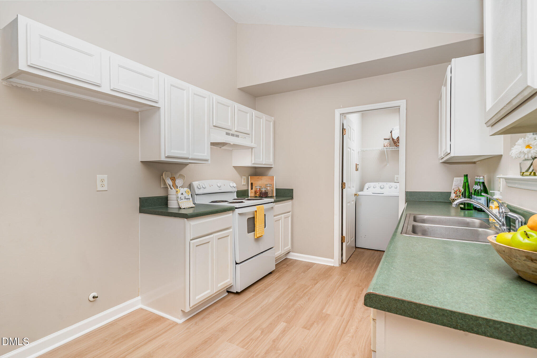 5414 Stanley Road Durham, NC 27704 - Photo 6 of 20 a kitchen with stainless steel appliances a stove a sink and a refrigerator