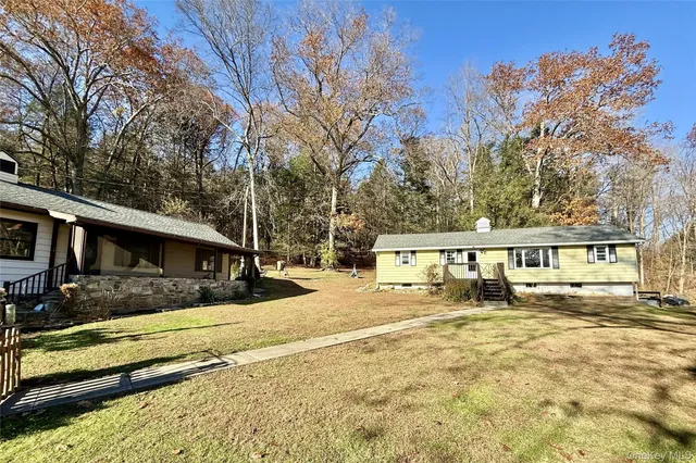 a view of a house with a yard covered in snow