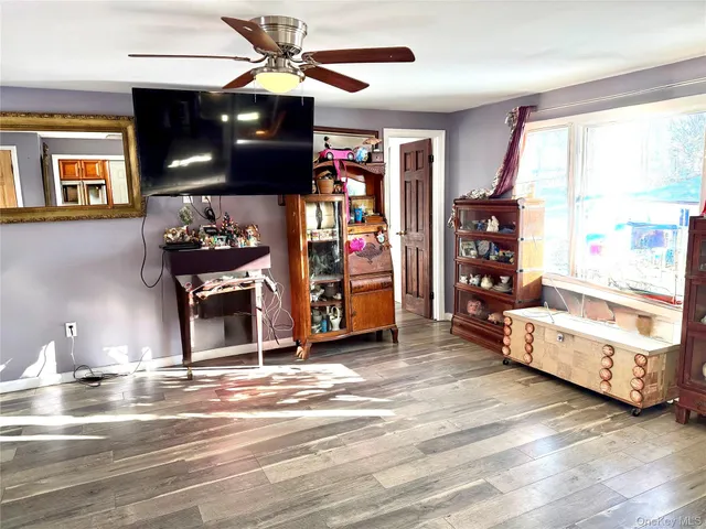 a living room with hard wood floors and a window