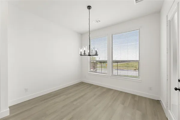 a view of kitchen with refrigerator and window