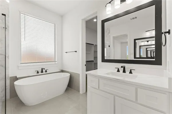 a bathroom with a bathtub and shower