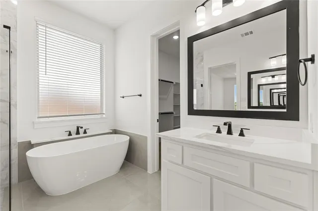 a bathroom with a bathtub and shower