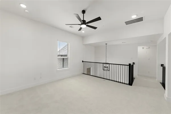 a view of a livingroom with a ceiling fan and window