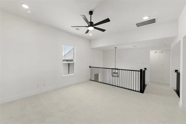 a view of a livingroom with a ceiling fan and window
