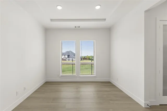 a view of an empty room with stairs and a window