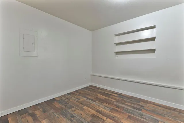 a view of a room with wooden floor