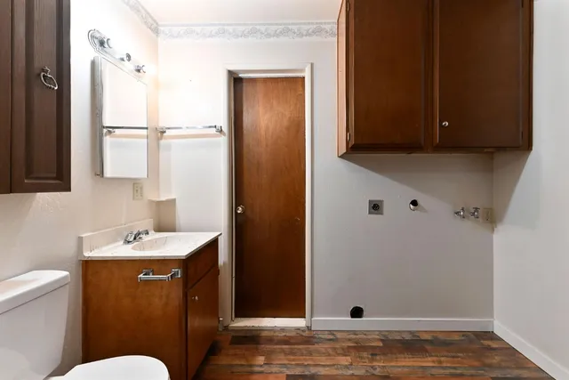a bathroom with a sink a toilet a mirror and vanity