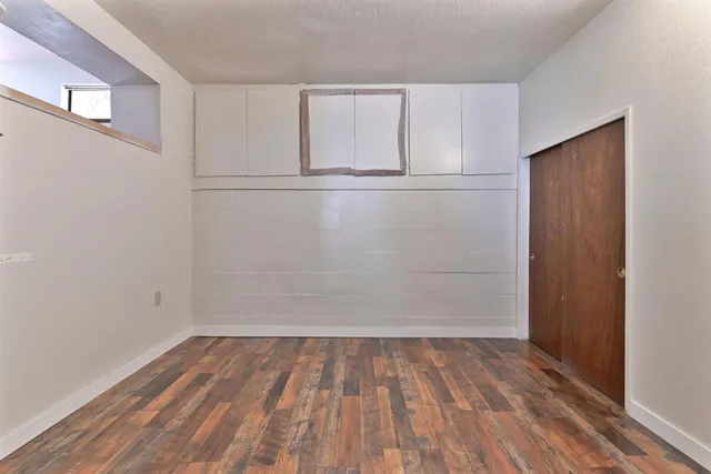a view of a room with wooden floor