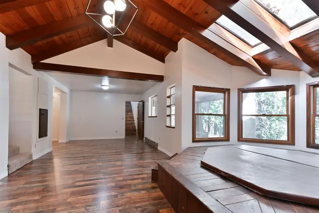 a room with wooden floor and windows