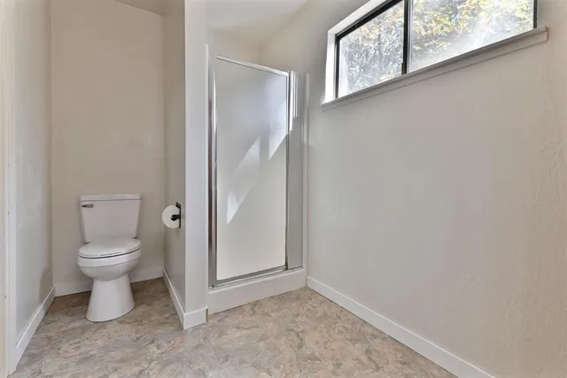 a white toilet sitting next to a bathroom sink