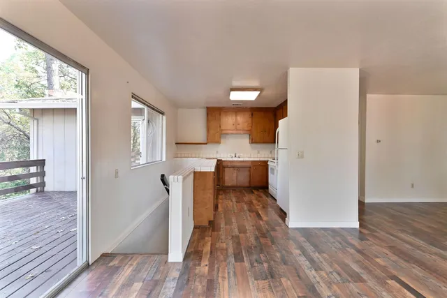 a view of a kitchen from the hallway with a window