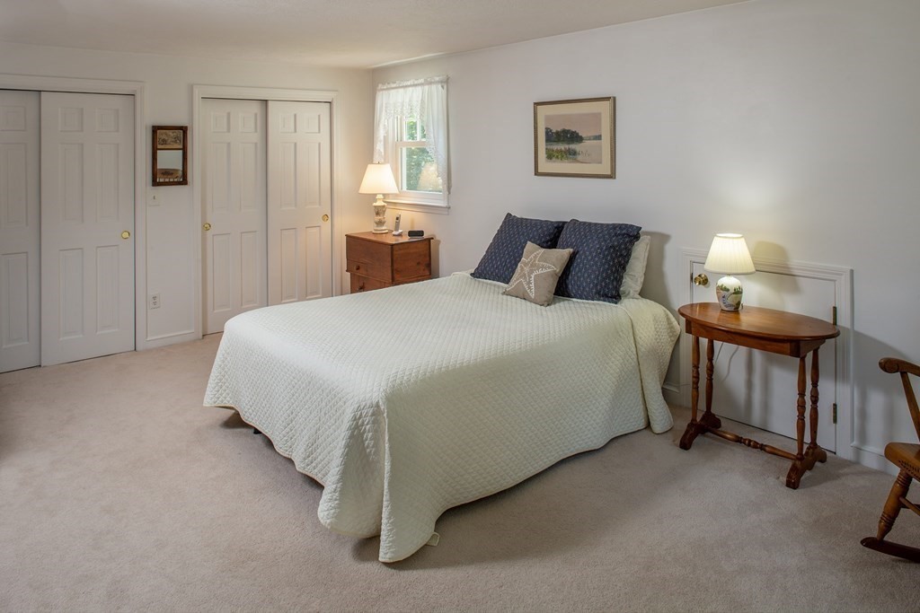 40 Union Hall Road Duxbury, MA 02332 - Photo 10 of 18 a bedroom with a bed and a lamp