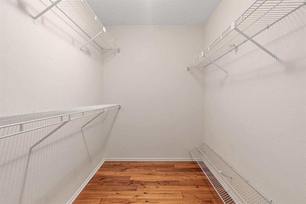 12660 Hillcrest Road, Unit 4203 Dallas, TX 75230 - Photo 11 of 16 Walk in closet featuring wood-type flooring