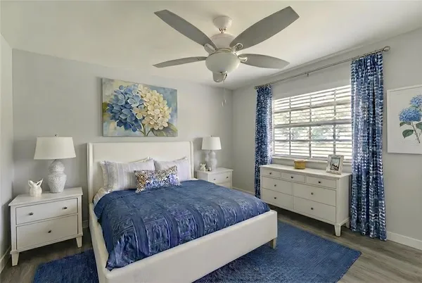 a bedroom with a large bed and a window