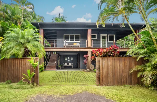 a front view of a house with garden