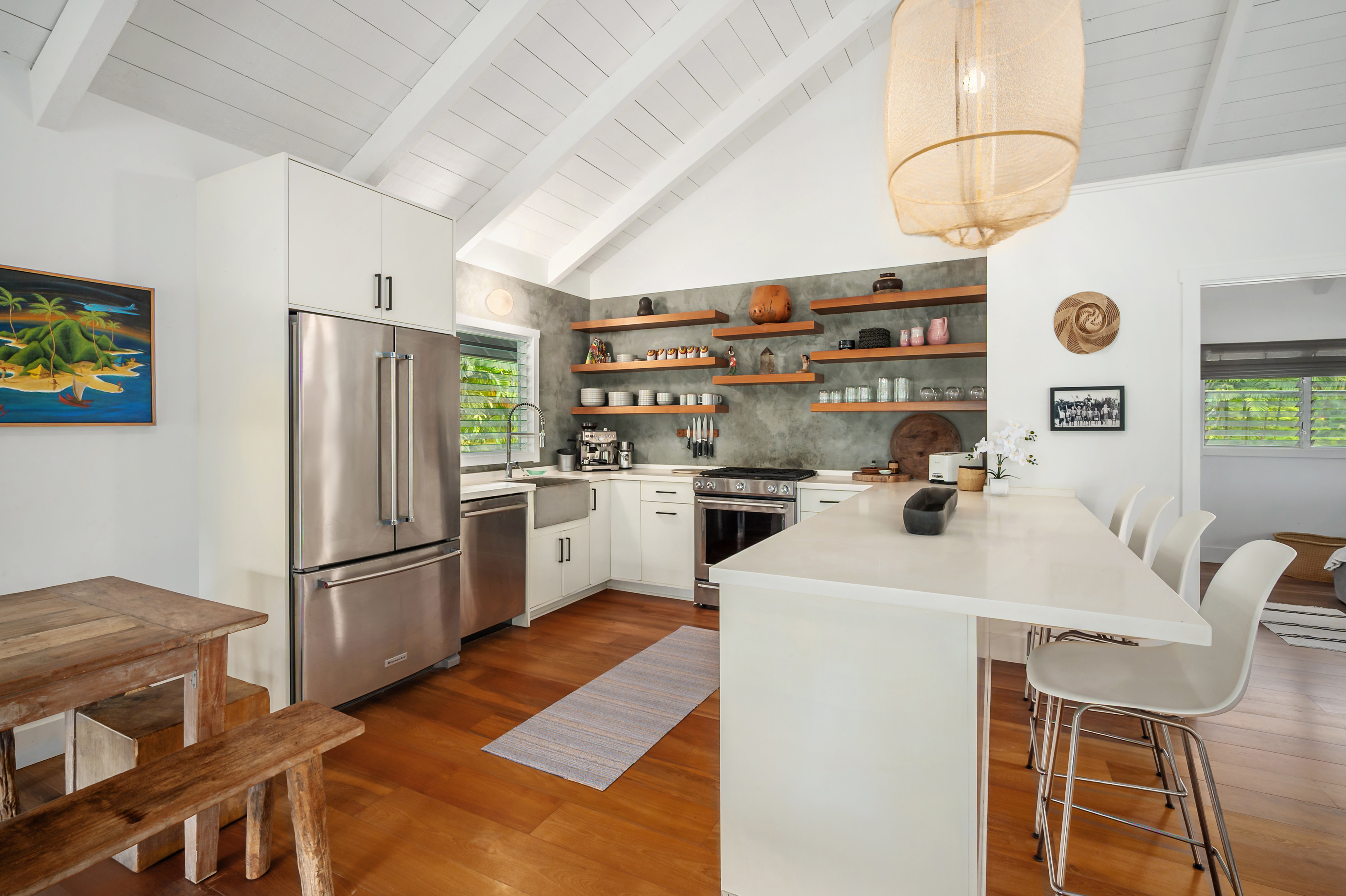 5410 Weke Road Hanalei, HI 96714 - Photo 8 of 23 a kitchen with stainless steel appliances a refrigerator a stove a sink and a stove with wooden floor