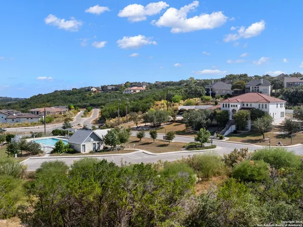 a view of a swimming pool with a yard and lake view