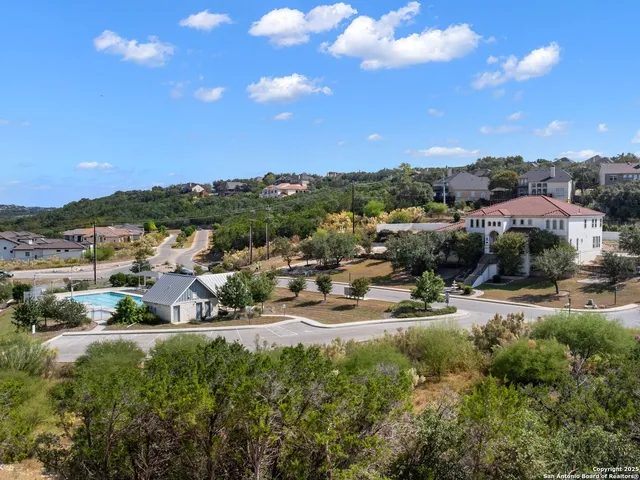 a view of a swimming pool with a yard and lake view