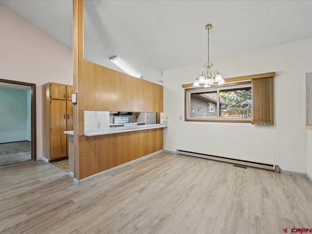a view of kitchen and kitchen with wooden floor