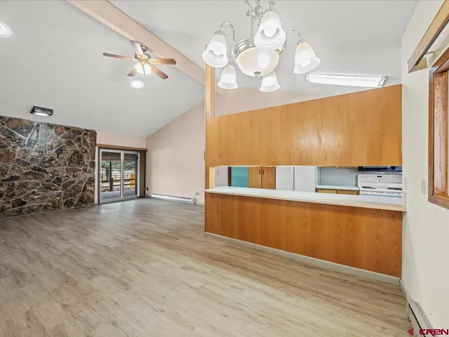 an empty room with wooden floor and a window