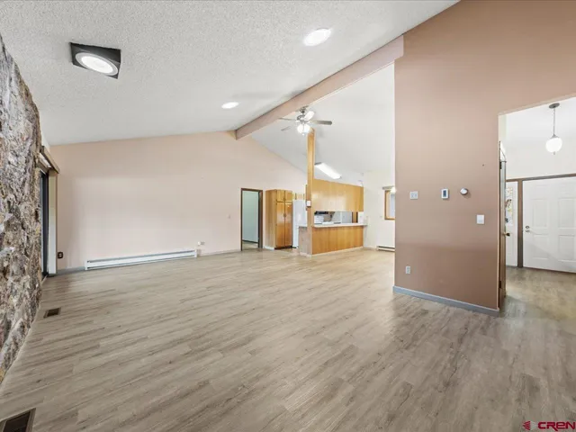 a view of a kitchen with refrigerator and mirror