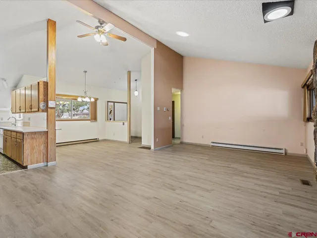 a kitchen with stainless steel appliances a refrigerator and a stove top oven
