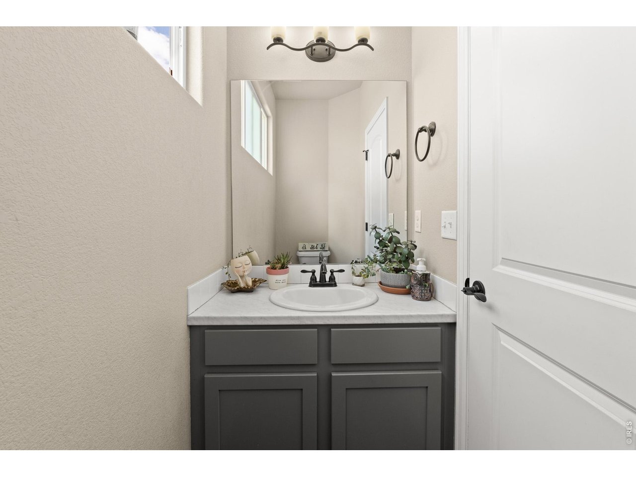 8847 16th St Road Greeley, CO 80634 - Photo 34 of 38 a bathroom with a sink vanity and a mirror