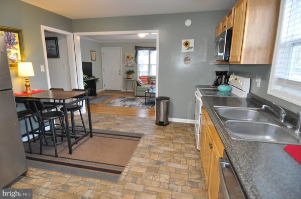 a kitchen with granite countertop a sink and a counter top space