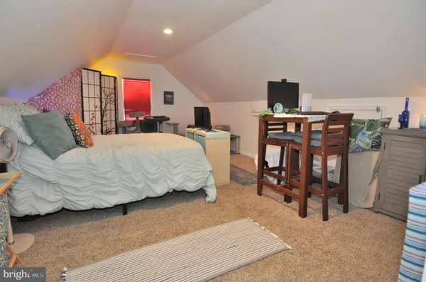 a bed room with a bed and a mirror