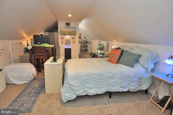 a bedroom with a bed and a couch