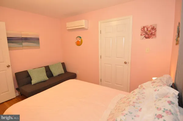 a bedroom with furniture and a flat screen tv