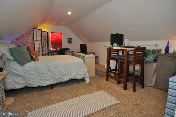 a bed room with a bed and a mirror