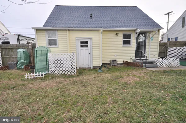 a backyard of a house with a table and chairs