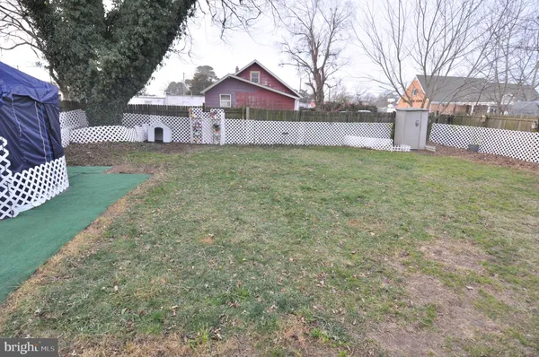 a view of a yard with a table and chairs