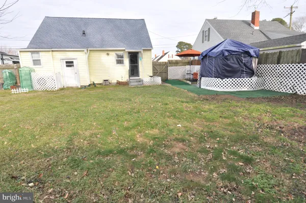 a view of a chair and table in the backyard of the house
