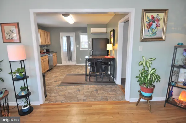 a kitchen with granite countertop a stove a sink and a refrigerator