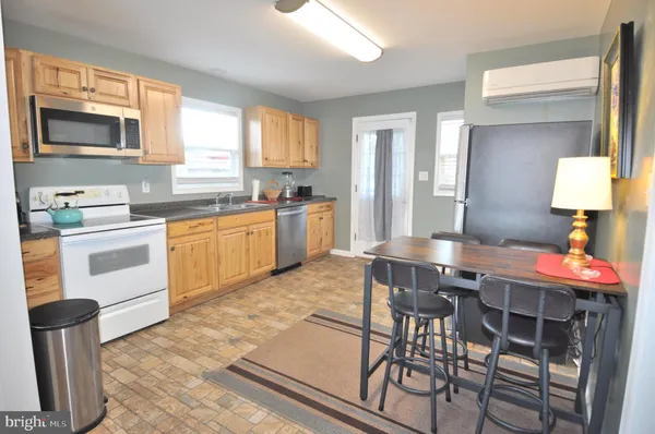 a kitchen with white cabinets white stainless steel appliances and sink