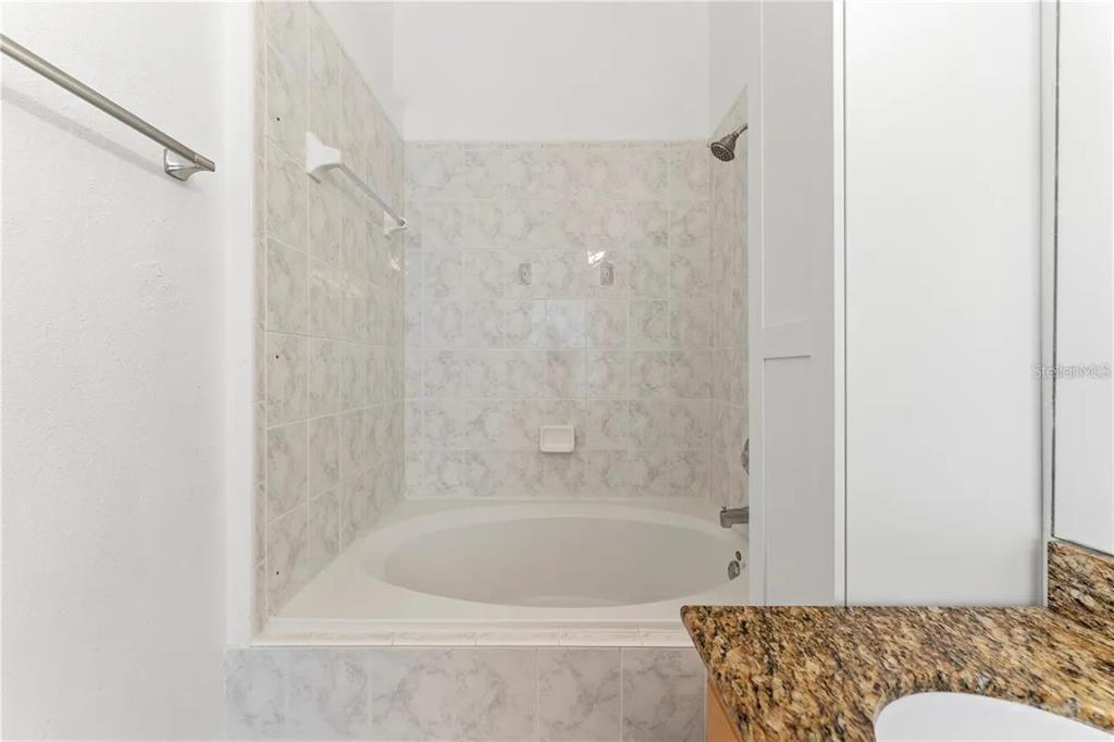 1437 Harbour Walk Road Tampa, FL 33602 - Photo 20 of 32 a bathroom with a bathtub and a shower