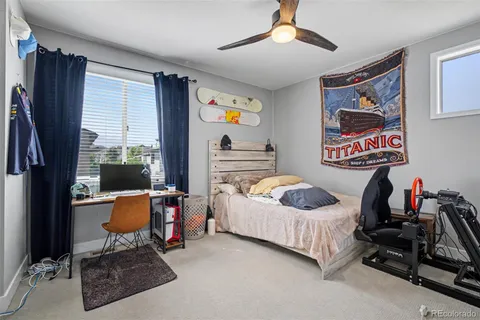 a bedroom with furniture and a flat screen tv