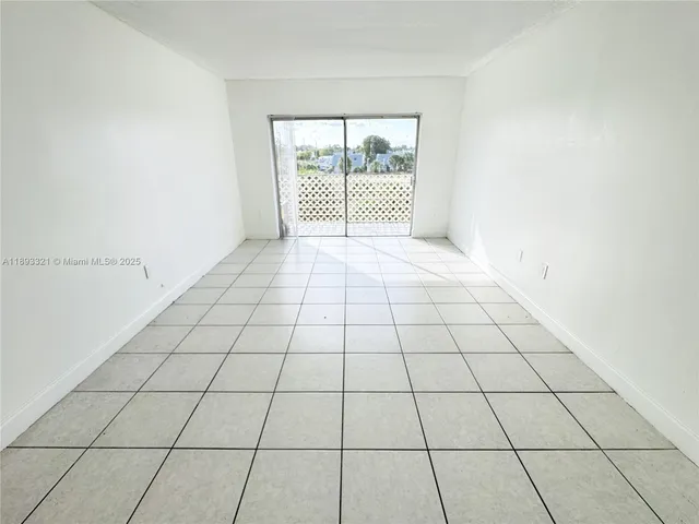 a view of empty room with white walls