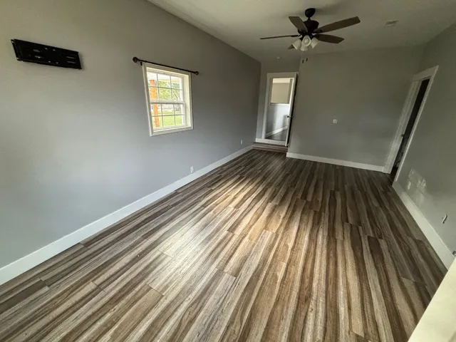 wooden floor in an empty room with a window