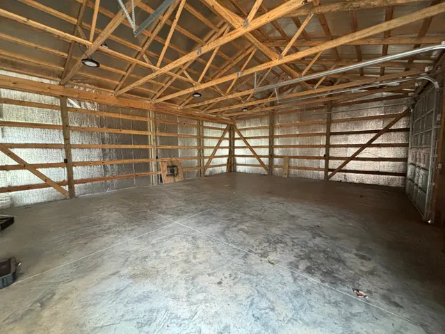a view of empty room with wooden ceiling