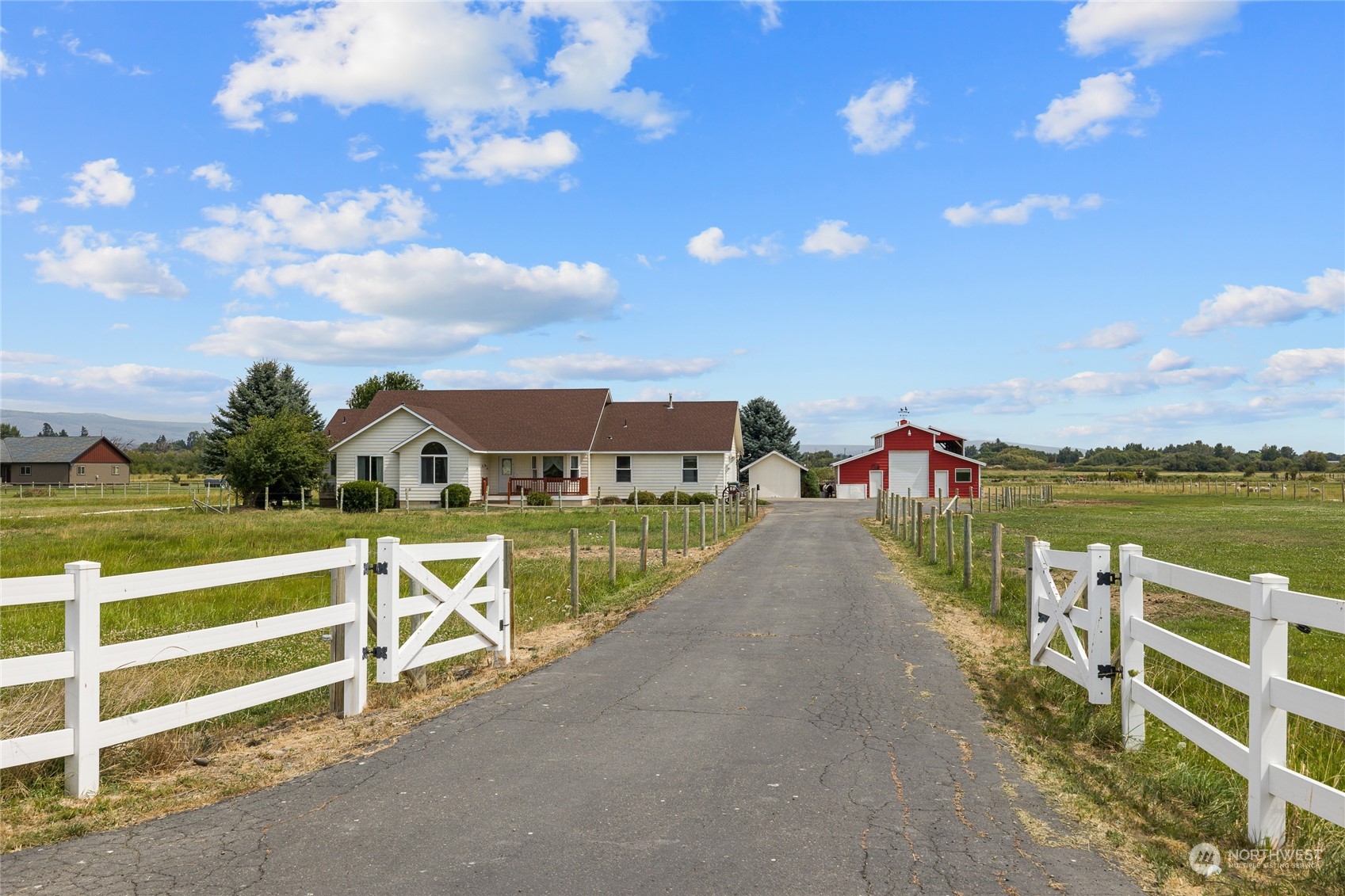 a view of a house with a floor to ceiling windows and a lake