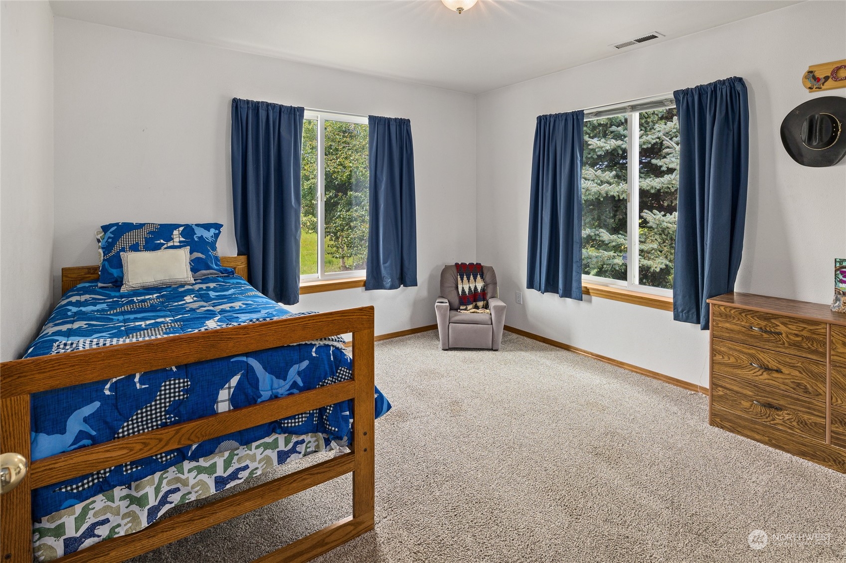 720 Klocke Road Ellensburg, WA 98926 - Photo 22 of 40 a bedroom with a bed a dresser and windows